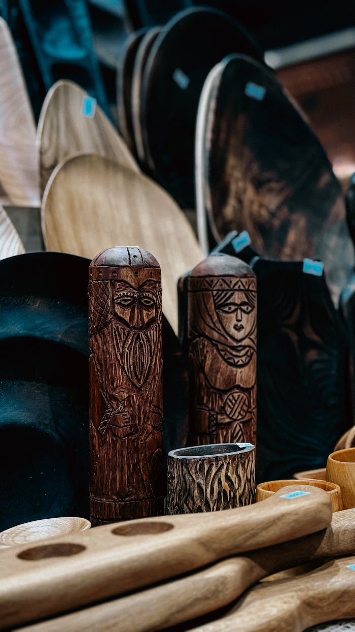 A variety of rustic wooden carvings and bowls on display, showcasing intricate craftsmanship.